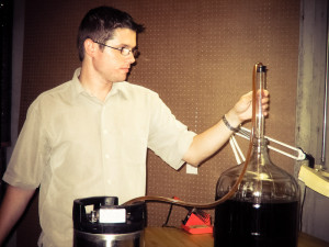 Racking (siphoning) the beer into the keg